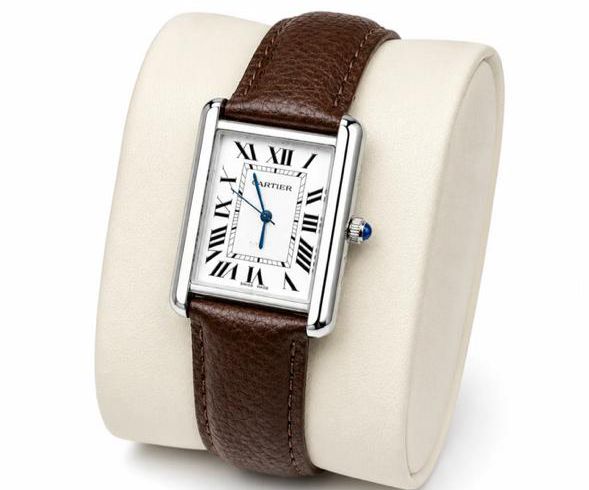 Timeless Tank silhouette with white Roman dial, blue steel hands, and textured brown leather strap. Classic luxury dress watch.
